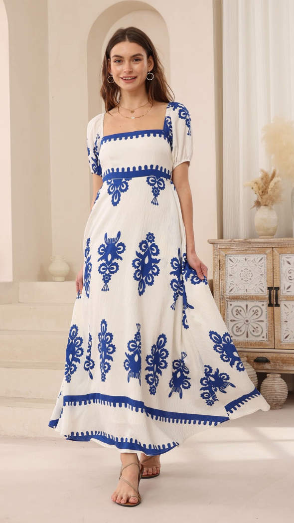 white and cobalt Nellie dress with puffy sleeves, fitted bodice, and flared maxi skirt
