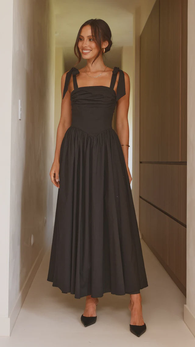 black Quinn maxi dress with adjustable shoulder ties, ruching on the bust and v-shaped waistline